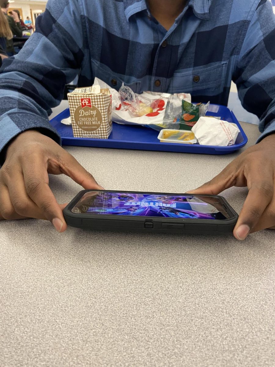 Junior Rithwick Lakshmanan playing Fortnite on Xbox Remote Play, on his phone, during lunch. 