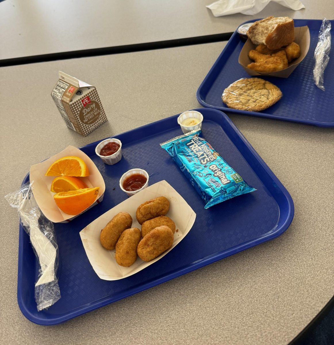 Two high school lunches display the typical portion sizes available to students.