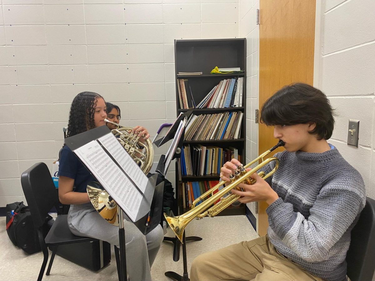 Band+students+Victoria+Rice%2C+Swetha+Narmeta%2C+and+Margil+Sanchez+Carmona+rehearse+for+the+State+Solo+and+Ensemble+Festival+inside+of+the+music+library.