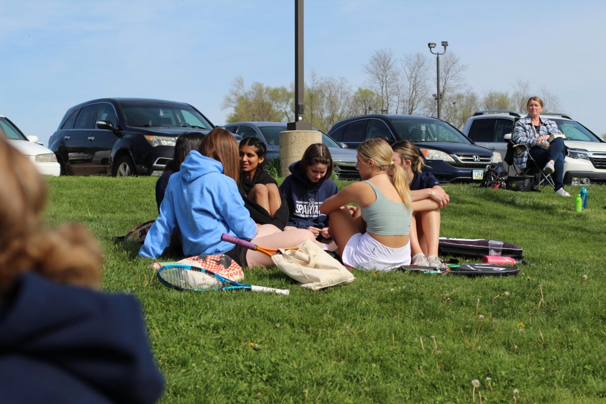 Pleasant Valley students socialize at a tennis meet.