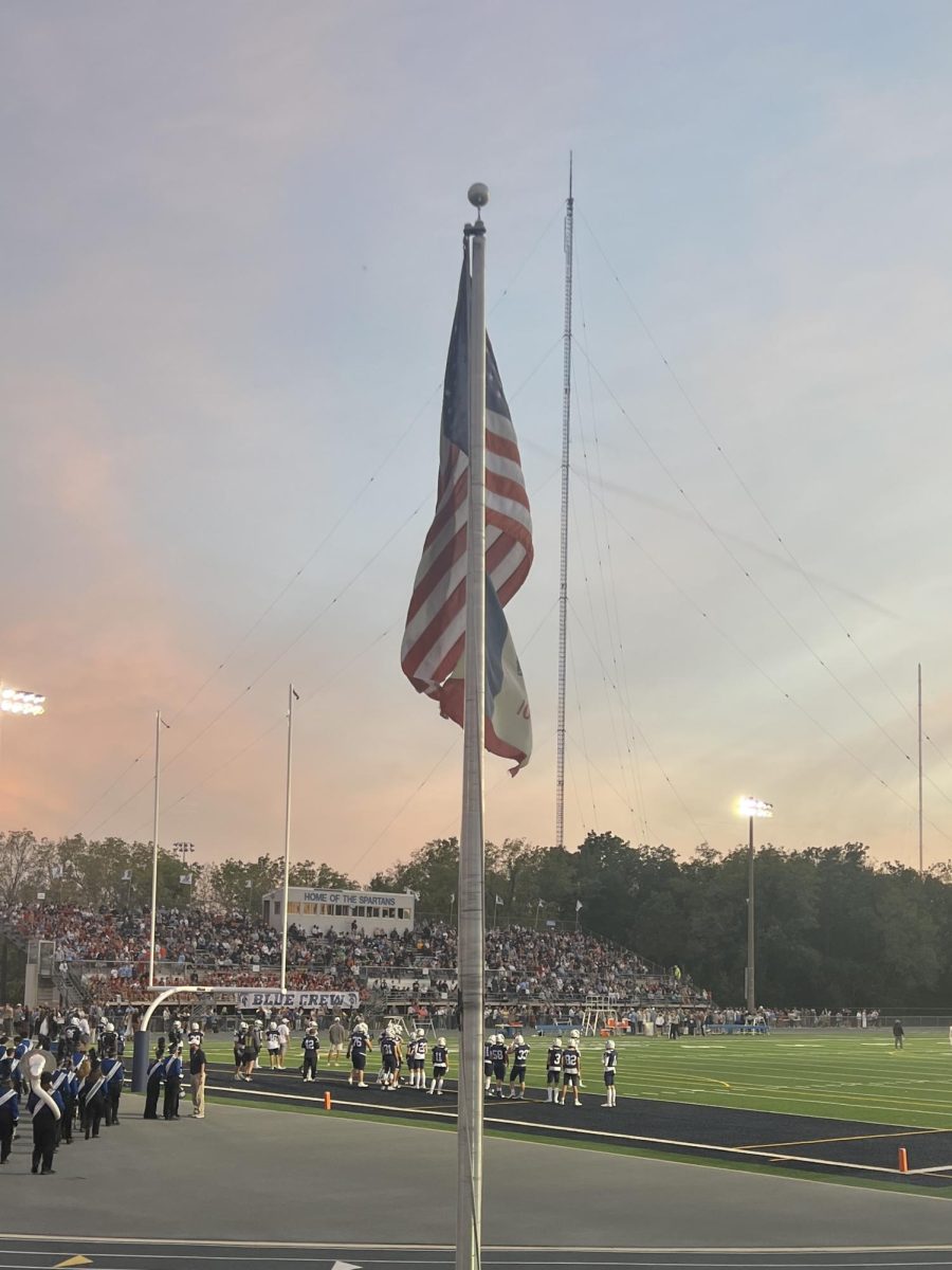 The flag raised in front of Spartan Stadium before Pleasant Valley’s homecoming game against Dubuque Senior. 