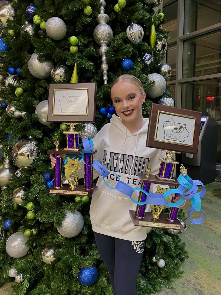 Senior dance captain Clare Tinsman posed at the state dance competition with her dance team state titles in jazz and pom. Tinsman is a 4 year state champion and her team danced to, “Never Break the Chain” to symbolize the teams dominant performances.

Photo Credit: Sharon Tinsman