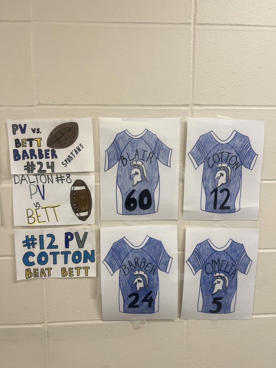 Cheerleaders hand draw posters for their designated football players each Friday and hang them throughout the halls of Pleasant Valley. 