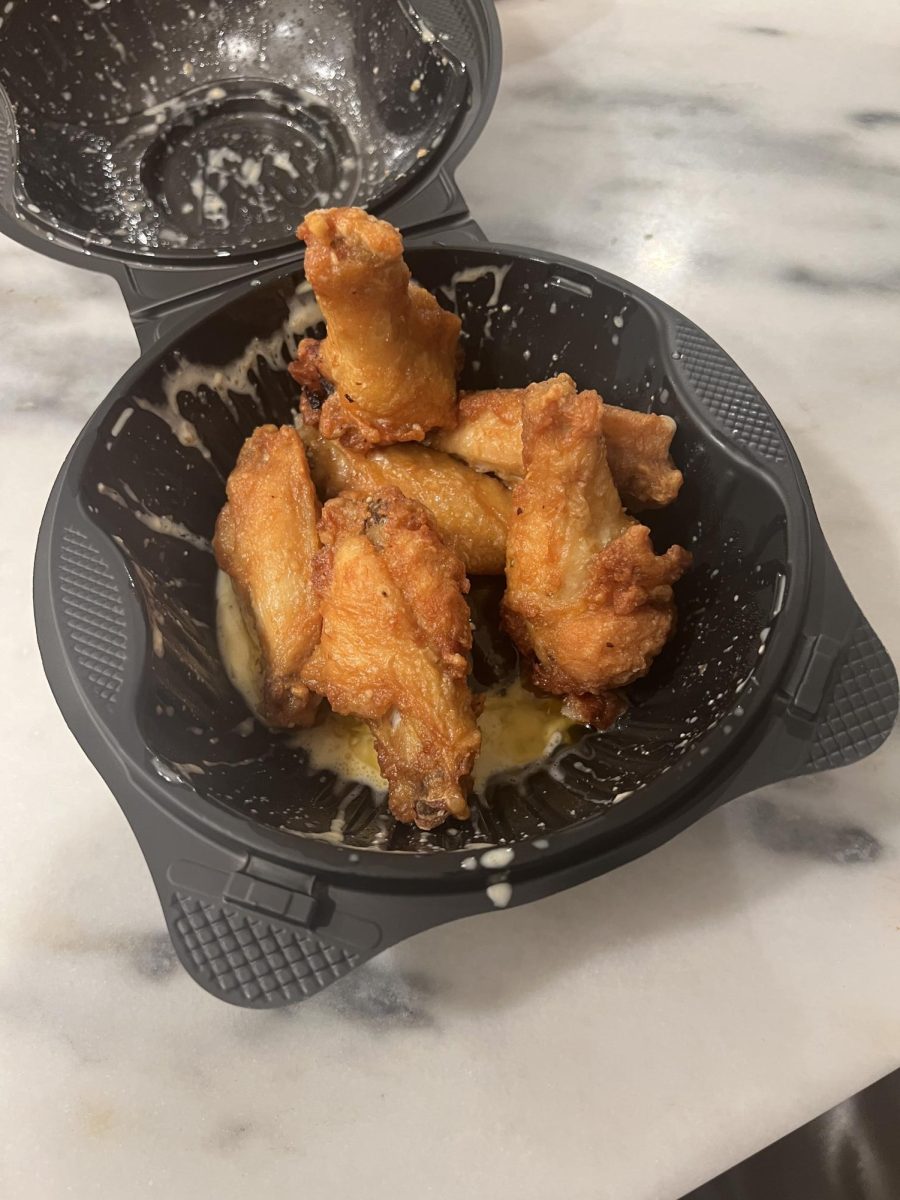 A batch of bone-in wings from Pizza Hut. These specific wings are tossed in butter and seasoned with garlic Parmesan seasoning.