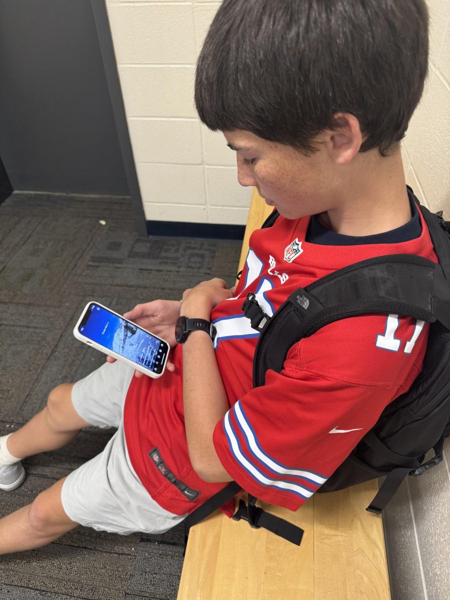 Sophomore Jack Belby scrolls through TikTok during passing period

