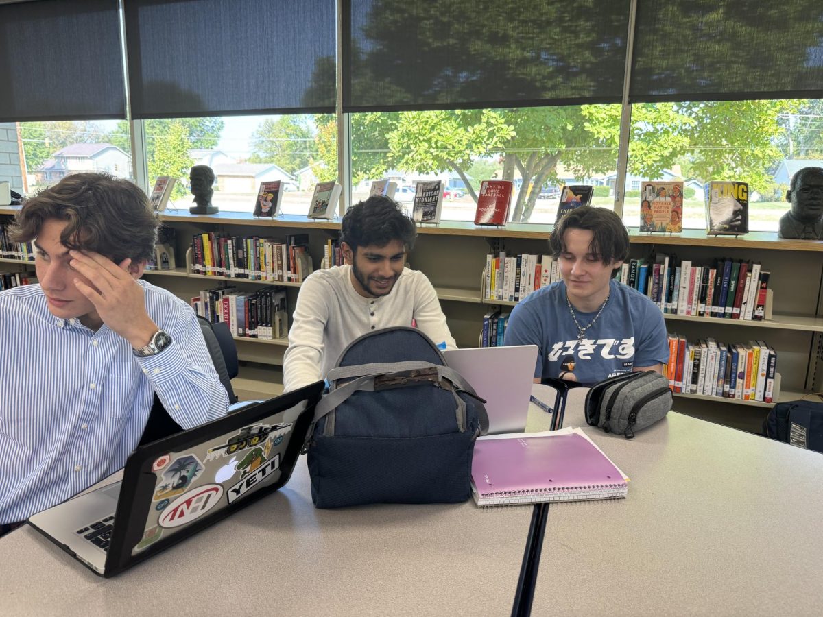 Students meet in the library to plan out their rising club's future meetings.