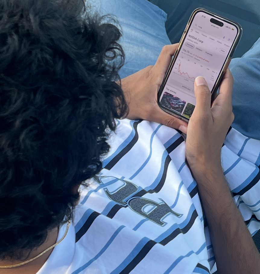 A student looking at the stock market and observing its trends.

