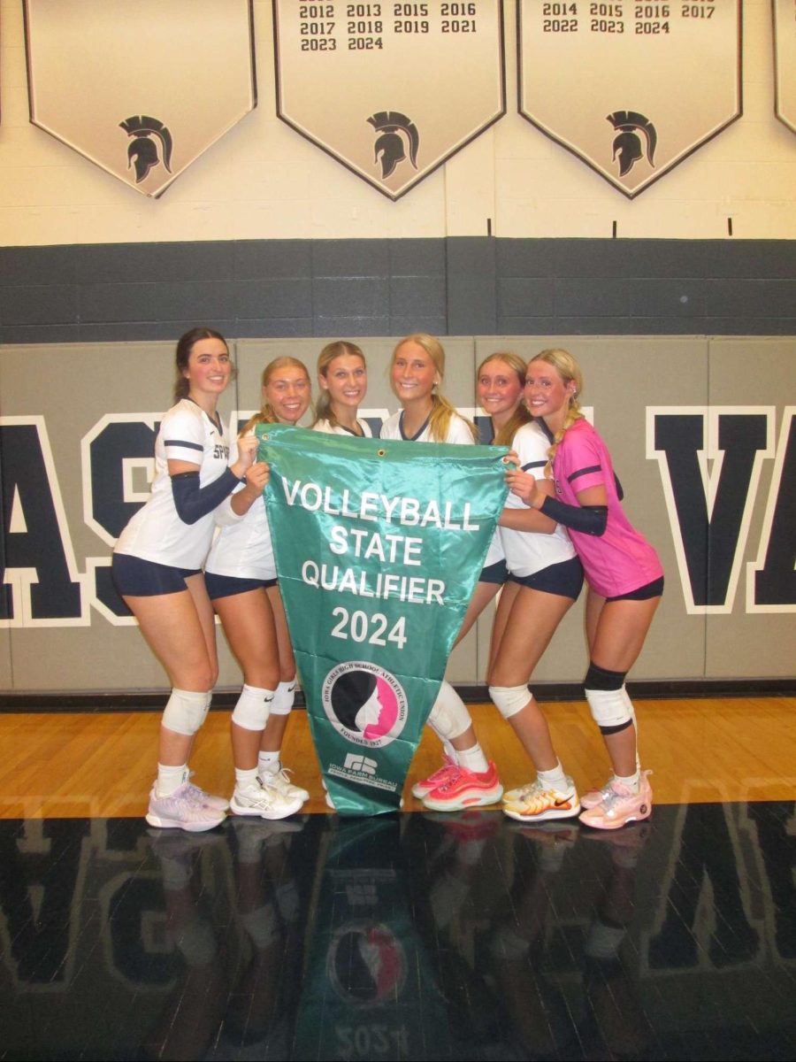 Volleyball seniors pose with state qualifier banner as they prepare to take on the state tournament.

Photo Credit to Isabelle Kremer
