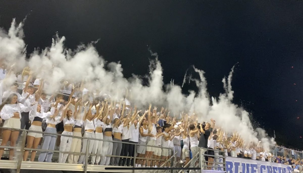 The Pleasant Valley student section throws baby powder into the air after the kickoff. The student section shows great school spirit at the white-out football game. 

Photo credit to Veronica Cox