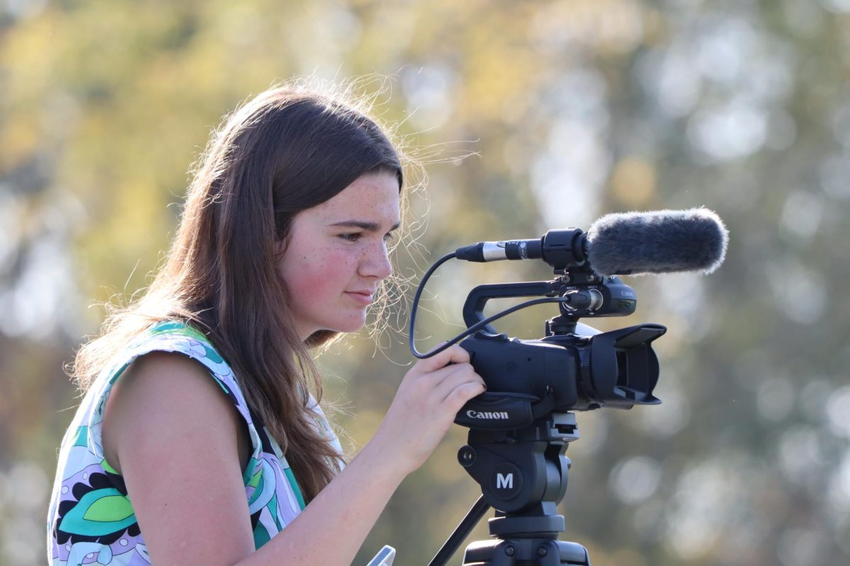 Sophomore Media Team member Allison Korczak operating a Media Team video camera while filming a PV football practice.

Photo Credit: PV Media Team