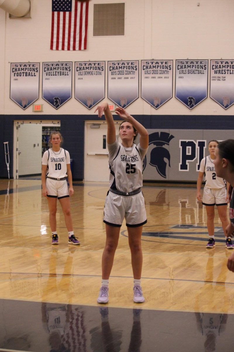 Junior Emma Volkstrof (25) shoots a basket, Dec. 3, 2024.