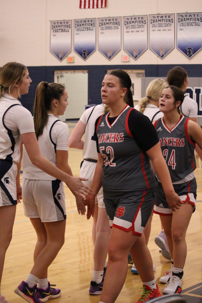 Lady Lancers and Spartans shake hands after the Spartans claim a victory, Dec. 3, 2024.