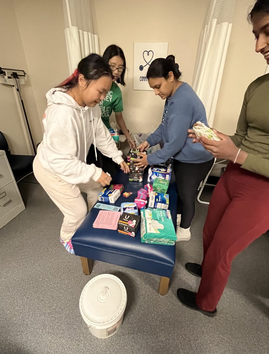 Students work in the nurses’ office to begin distributing donations received from the hygiene drive.