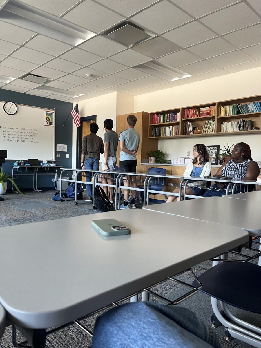 Classroom shows conflicting beliefs as students sit during the pledge of allegiance.