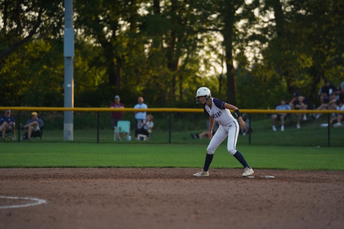Junior Ashley Hansen leads off of second base during a home softball game. 
Photo Credit to Drake Hanson.