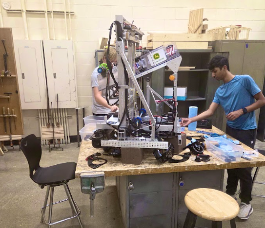 Robotics team members working on robot.