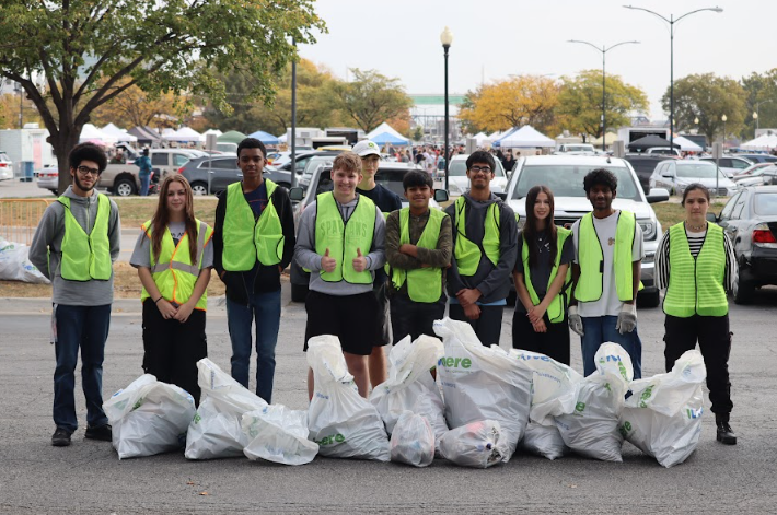 Pleasant Valley High School students picking up trash near the Mississippi River as an act of community service